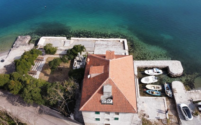 Ancient stone villa on the first line with a pier