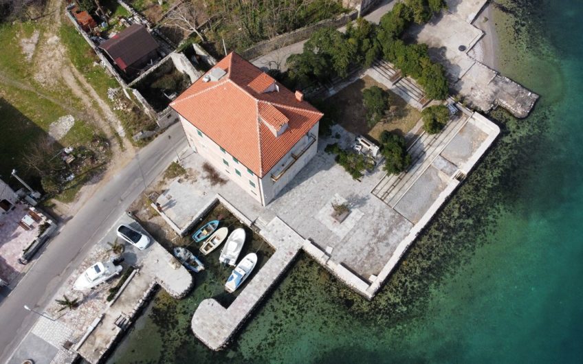 Ancient stone villa on the first line with a pier