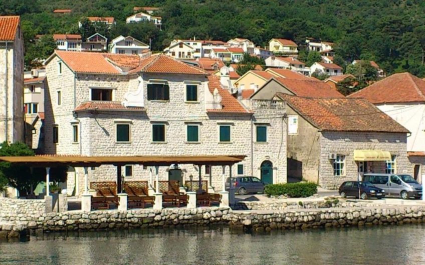 Ancient stone house with a restaurant on the seashore